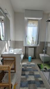 une salle de bain avec un lavabo et des toilettes et une fenêtre dans l'établissement Andry House, à Peschiera del Garda