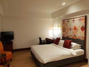 Postel nebo postele na pokoji v ubytování Inventree Hotel,Bangalore
