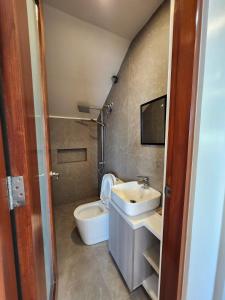 a bathroom with a toilet and a sink at The Hillside Villa Tagaytay in Laurel +36 photos