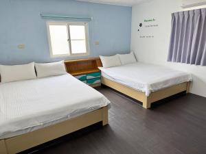 Postel nebo postele na pokoji v ubytování 珊瑚礁民宿