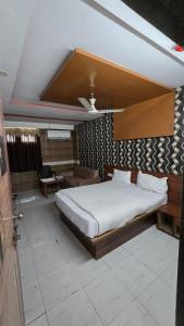 艾哈迈达巴德Hotel Anand Place的带一张大床和一张沙发的卧室