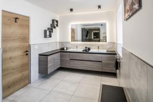 a bathroom with a sink and a mirror at Stylish Alpine Apartment with Terrace, Fireplace & Mountain View near Sterzing - Villa Tribulaunblick in Colle Isarco
