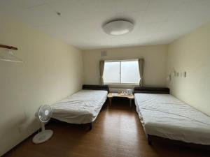 Voodi või voodid majutusasutuse Guesthouse Yoichi toas