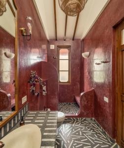 a bathroom with a toilet and a sink at Villa Fado - 4BHK Villa with Private Pool in Assagao, Kitchen, Caretaker in Assagao