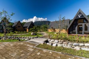 a home with a stone path and a house at 微風星語名宿WindStar B&B in Jian