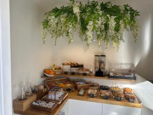 a shelf with food and flowers hanging from a wall at Leone Camere D'autore - Rooftop Prince Centro Storico in Naples