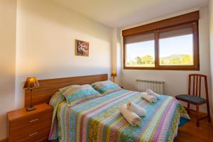 a bedroom with a bed with two towels on it at La Pergola in Santillana del Mar