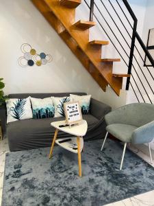 a living room with a couch and a table at Homefortzone near D' outlet lima in Sampong