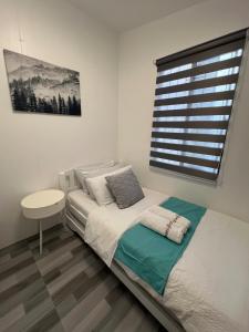 a small bedroom with a bed and a window at Homefortzone near D' outlet lima in Sampong +13 photos