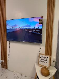a flat screen tv hanging on a wall at Homefortzone near D' outlet lima in Sampong +13 photos