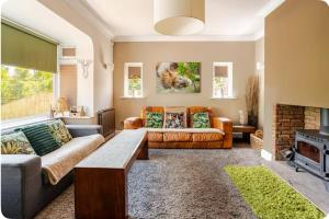 a living room with two couches and a fireplace at Entire Family Home By The Sea in Scarborough