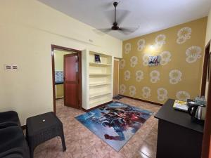 a living room with a spider man rug on the floor at V2V Homestay in Mayiladuthurai