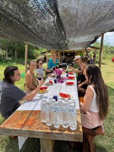 a group of people sitting around a picnic table at The Nest, Pai Love Resort in Thung Yao