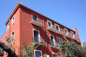 a red building with balconies on the side of it at Villa Astoria in Taormina