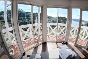 a gym with large windows and a view of the water at IST Villa 02 Seaside for 6 people in Bizen