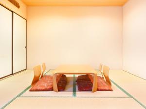 a table and two chairs in a room at Hotel Abest Sapporo in Sapporo +151 photos