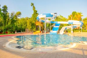 a pool with a water slide in a park at Lykia Botanika Beach Fun & Club - All Inclusive in Fethiye