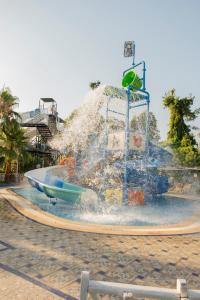 a water fountain in the middle of a park at Lykia Botanika Beach Fun & Club - All Inclusive in Fethiye