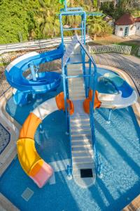a water slide in a swimming pool at Lykia Botanika Beach Fun & Club - All Inclusive in Fethiye