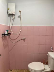 a pink bathroom with a shower and a toilet at Seasalt 1 Cozy Studio with Full kitchen and fast WiFi in Thong Sala