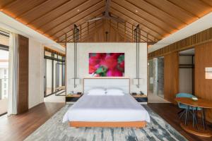 a bedroom with a large bed and a table at Hyatt Regency Seragaki Island Okinawa in Onna
