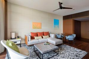 a living room with a couch and a table at Hyatt Regency Seragaki Island Okinawa in Onna