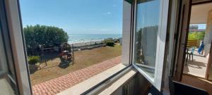 a view of the ocean from a window at Villaggio Rossi in Porto Potenza Picena +3 photos