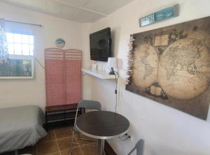 a room with a table and a map on the wall at Beachfront Studio with Private Kitchen and Bath in Algeciras