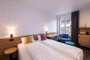 Voodi või voodid majutusasutuse Hotel Loge toas