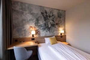 Voodi või voodid majutusasutuse Hotel Loge toas