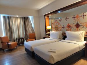 Postel nebo postele na pokoji v ubytování Inventree Hotel,Bangalore