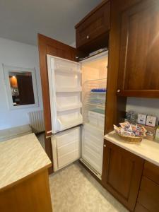 an empty refrigerator with its door open in a kitchen at Cavallino Holiday House in Cavallino-Treporti +56 photos