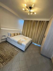 a bedroom with a bed and a ceiling fan at Pamoja Stays in Rungiri +3 photos