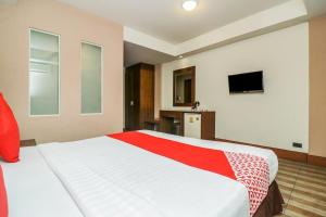 a bedroom with a large white bed with a red blanket at Dancenter JA Siam City in Pattaya +16 photos