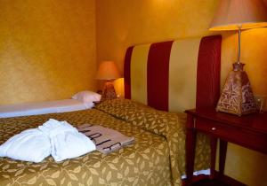 a hotel room with a bed with towels on it at AmbientHotels Panoramic in Rimini