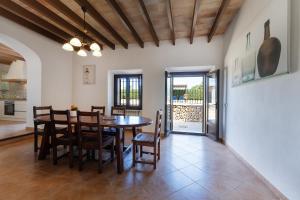 a kitchen and dining room with a table and chairs at Villa con piscina, BBQ, terraza y wifi in Santanyi