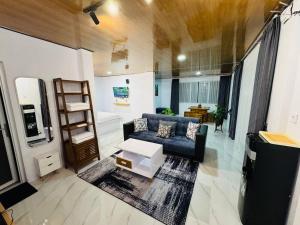 a living room with a couch and a table at SunSet Lawu Kemuning, Villa, Full House 3 Bed, Free BBQ, Free Float Light Breakfast in Karanganyar