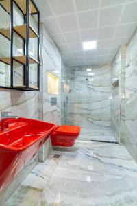 a bathroom with a red sink and a red toilet at Aria Riva Apart Hotel in Alanya