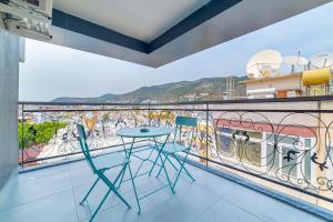 a balcony with a table and chairs on it at Aria Riva Apart Hotel in Alanya