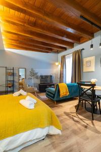 a bedroom with a yellow bed and a couch at Casina de Santa Ana I By Silastur in Siero +19 photos