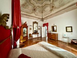 a large room with a bedroom with a bed and a table at Le Foglie Di Acanto in Lucera +150 photos
