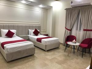 Postel nebo postele na pokoji v ubytování Holiday One Hotel & Suites
