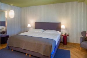 A bed or beds in a room at Alma Hotel