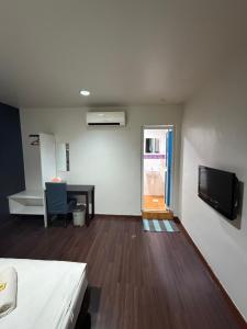 a room with a bed and a tv on a wall at 1st Living Subang SS15 in Subang Jaya