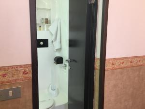 a bathroom with a shower with a toilet in it at Hotel Liberty in Sanremo