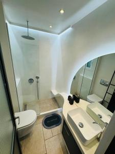 a bathroom with a white sink and a toilet at Sani Nature Retreat - Elegant Stay by Forest and Sea in Sani Beach