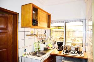 a kitchen with a sink and a counter top at Studio A4 Fustel City Bonamoussadi Santa Lucia,Wifi, chaînes TV, gardien in Douala