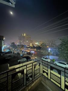 a view of a city at night from a balcony at Hotel Hayat Palace Johar Town in Lahore