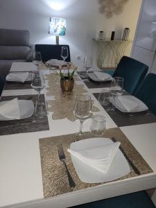 a table with plates and wine glasses on it at Appartement Ponte de lima in Ponte de Lima