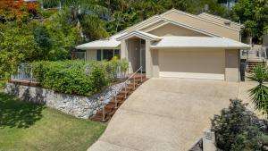 a small house with a driveway in front of it at Spacious 4-Bed Family Retreat with Pool Near Beach in Coolum Beach